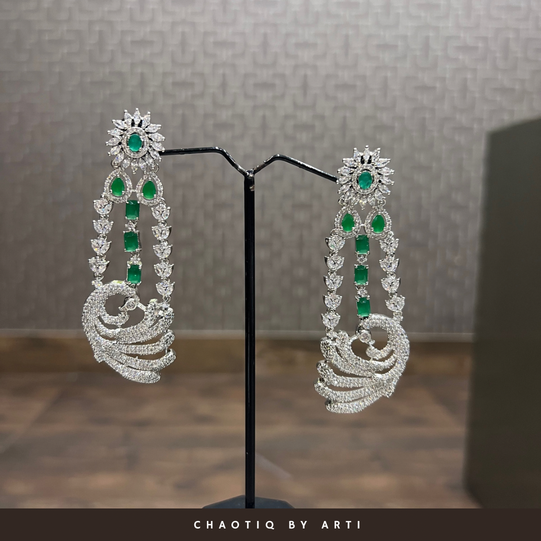 Layered diamond set with a peacock shaped pendant
