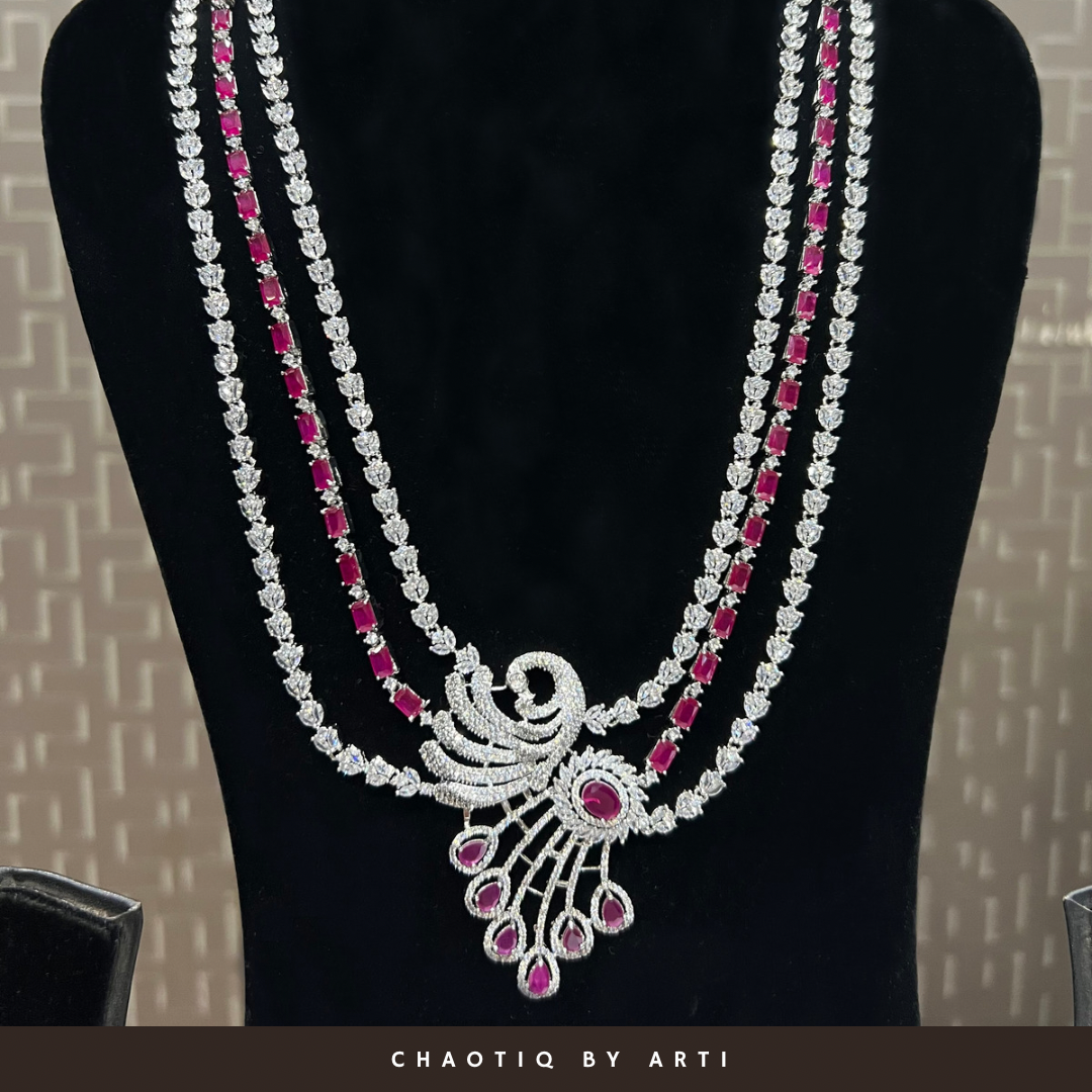 Layered diamond set with a peacock shaped pendant