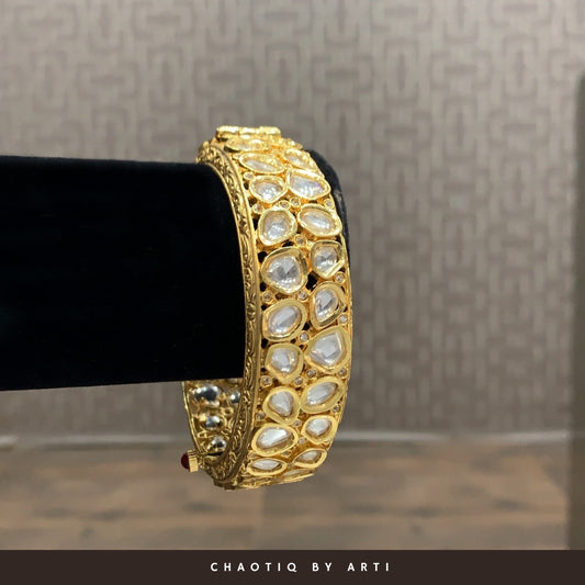 Elaborately crafted gold and polki bangle
